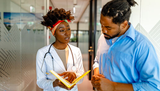 A health care worker discussing a topic with a patient 