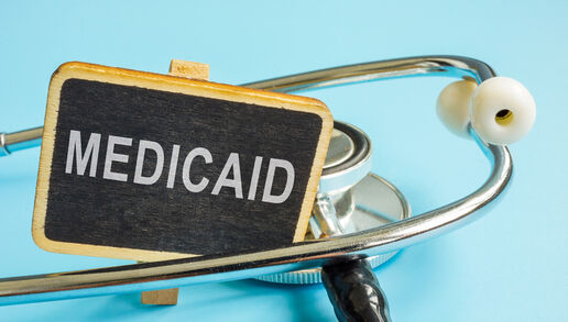 Medicaid written on a chalkboard and settled in between a stethoscope