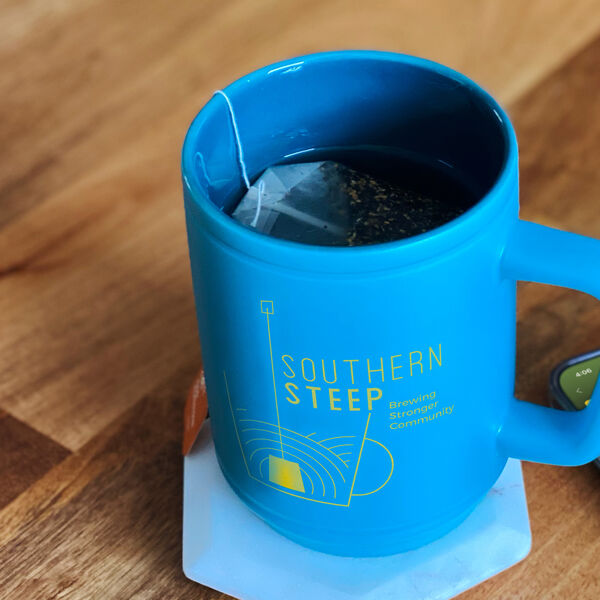 A Southern Steep coffee mug on a table.
