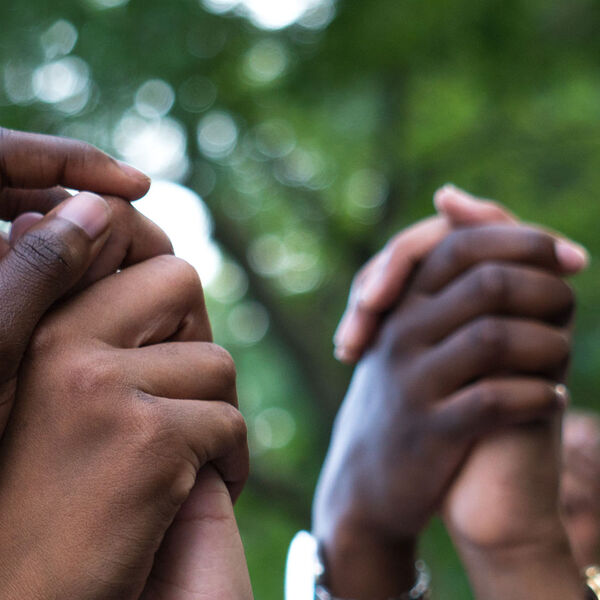 A group of people with their hands in the air.