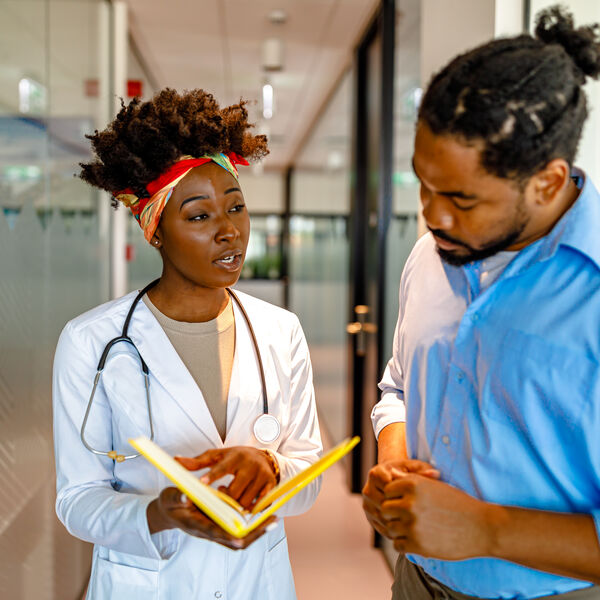A health care worker discussing a topic with a patient