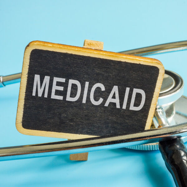 Medicaid written on a chalkboard and settled in between a stethoscope