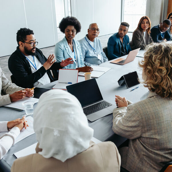 a group of people sitting at a conference table